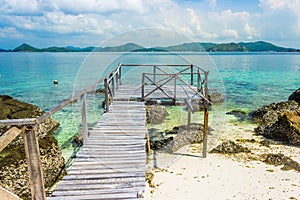 Tropical island rock and wood bridge on the beach with blue sky. Koh kham pattaya thailand