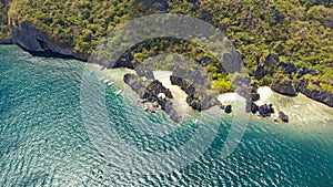 Tropical island with rocky shore and white beach.Tourist routes by boat