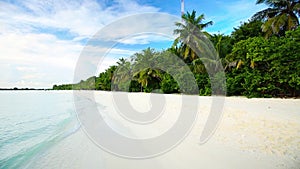 Tropical island with sandy beach with palm trees and tourquise clear water