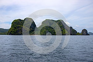 Tropical island in still sea. Green mountain marine landscape. Philippines island hopping banner template