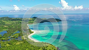 A tropical island with a turquoise lagoon and a sandbank. Caramoan Islands, Philippines.