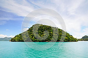 Tropical island in turquoise sea with mountain covered with rainforest at the Koh Chang island, Thailand.