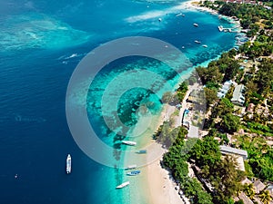 Tropical island with village, beach and turquoise crystal ocean, aerial view. Gili islands