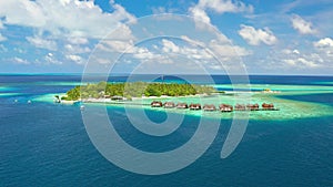 Tropical island with watrer villas and coconut palm trees, blue lagoon, white sandy beach at Bora Bora island, Tahiti