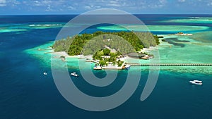 Tropical island with watrer villas and coconut palm trees, blue lagoon, white sandy beach at Bora Bora island, Tahiti