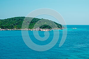 Tropical islands of ocean blue sea water and white sand beach at Similan Islands with famous Sail Rock, Phang Nga