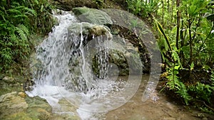 Tropical jungle waterfall with strong stream, Java, Indonesia