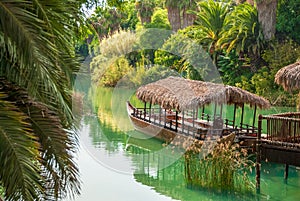 Tropical landscape. Lagoon with clear turquoise water rainforest and ancient boat made of wood.