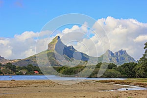 Tropical landscape of lush greenery,mountains and small town on Mauritius Coast