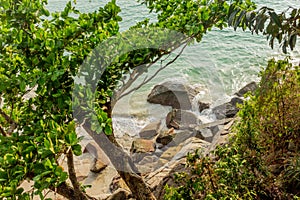 Tropical landscape of rocky beach and ocean in Thailand.