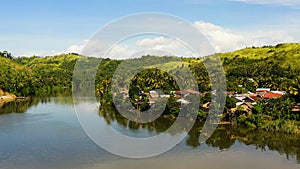 Tropical landscape in sunny weather. Village by the river. The nature of the Philippines, Samar