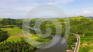 Tropical landscape in sunny weather. Village by the river. The nature of the Philippines, Samar