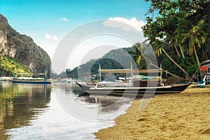 Tropical landscape with traditional boats of the Philippines. boats standing at the shore of Elnido, the island of Palawan