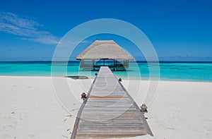 Tropical landscape with wooden bridge and hut on the water at Maldives