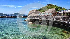 Tropical landskape. pier for boats between the rocks on the white beach of the Nang Yuan island