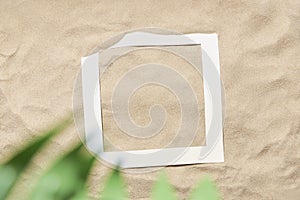 Tropical layout, sand background and paper empty frame: summer, beach, vacations