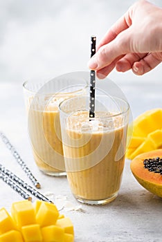 Tropical mango coconut smoothie in a glass