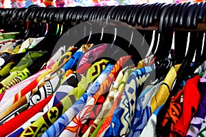 Tropical men shirts displayed on clothes hangers in Rarotonga ma