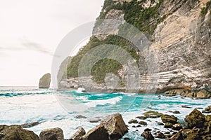 Tropical ocean with waves and rocky cliff in Bali