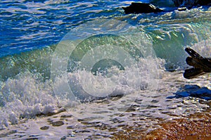 Tropical ocean waves splashing onto beach shore