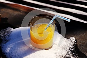 A tropical orange juice chilling in snow in hot days