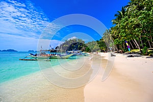 Tropical Papaya beach at paradise coast, El Nido, Palawan, Philippines. Tour A Route. Coral reef and sharp limestone cliffs