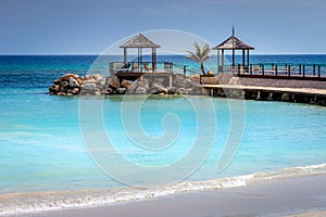 Tropical paradise: caribbean beach with pier and gazebo, Montego Bay, Jamaica