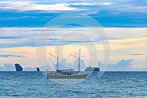 Tropical paradise sunset turquoise water beach limestone rocks Krabi Thailand