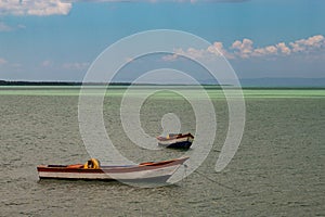 Tropical paradise typical scenery: colored wooden boats docked in the sea. Miches Bay or Sabana De La Mar lagoon, northern