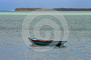 Tropical paradise typical scenery: colored wooden boats docked in the sea. Miches Bay or Sabana De La Mar lagoon, northern