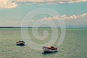 Tropical paradise typical scenery: colored wooden boats docked in the sea. Miches Bay or Sabana De La Mar lagoon, northern photo