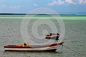 Tropical paradise typical scenery: colored wooden boats docked in the sea. Miches Bay or Sabana De La Mar lagoon, northern photo