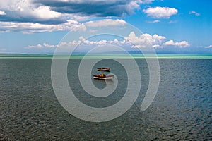 Tropical paradise typical scenery: colored wooden boats docked in the sea. Miches Bay or Sabana De La Mar lagoon, northern photo