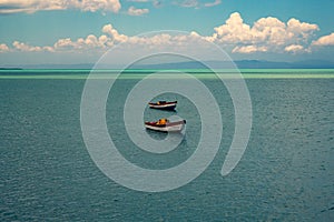 Tropical paradise typical scenery: colored wooden boats docked in the sea. Miches Bay or Sabana De La Mar lagoon, northern photo