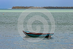 Tropical paradise typical scenery: colored wooden boats docked in the sea. Miches Bay or Sabana De La Mar lagoon, northern photo