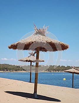 Tropical parasols on the Orellana dam beach photo