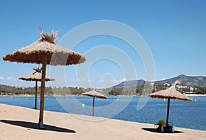 Tropical parasols on the Orellana dam beach photo