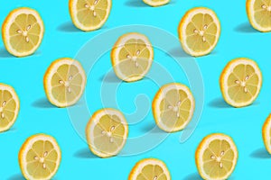Tropical pattern of lemon citrus wheel on green mint color background.