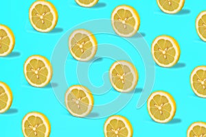 Tropical pattern of lemon citrus wheel on green mint color background.