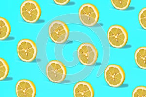 Tropical pattern of lemon citrus wheel on green mint color background.