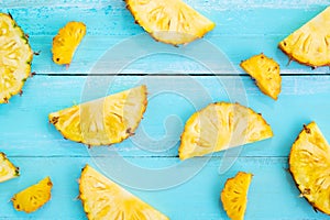 Tropical pineapple slices on wood plank blue color.