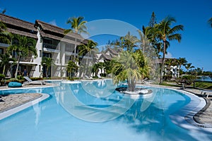 tropical pool with beach chairs and umbrellas, swimming pool in Mauritius