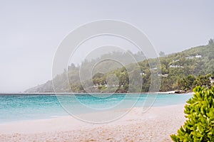 Tropical rain covered Anse Intendance beach on Mahe island in Seychelles