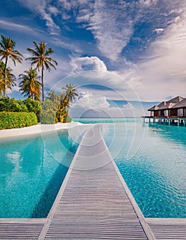 Tropical resort infinity pool with overwater bungalows