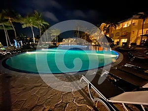 Tropical resort pool at night