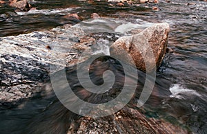 Tropical river flowing rapid water and rocks landscape