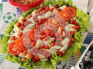 Tropical salad with tomatoes, lettuce, cherry tomatoes, palm heart. To be healthy