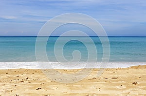 Tropical sandy beach with blue ocean and blue sky background image for nature background or summer background