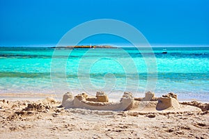 Tropical sandy beach with sandcastles and turquoise water, in Elafonisi, Crete