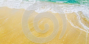 Tropical sandy beach and sea wave from above. Sand and water on tropical island top view. Exotic island summer holiday vacation